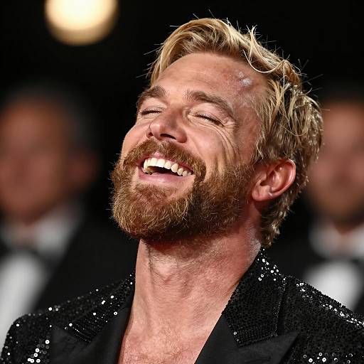 Joyful Man in Sequined Jacket Laughing