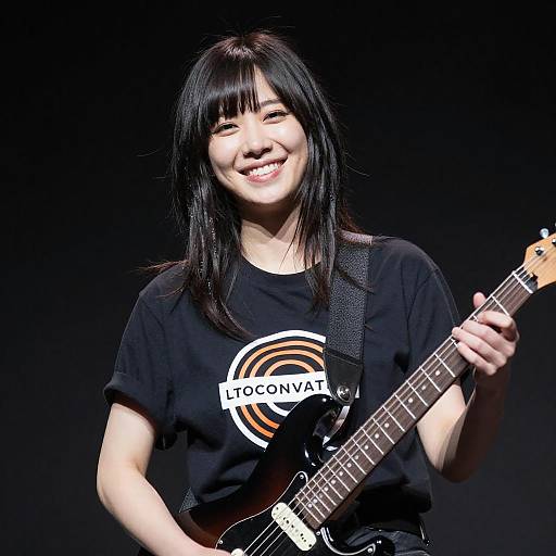 Smiling Woman with Electric Guitar