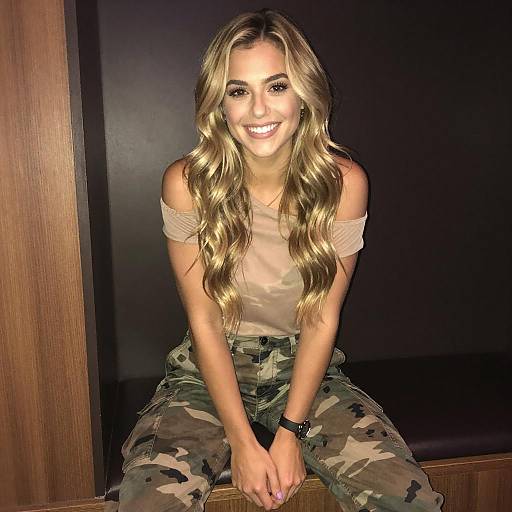 Smiling Woman in Sheer Top and Camo Pants