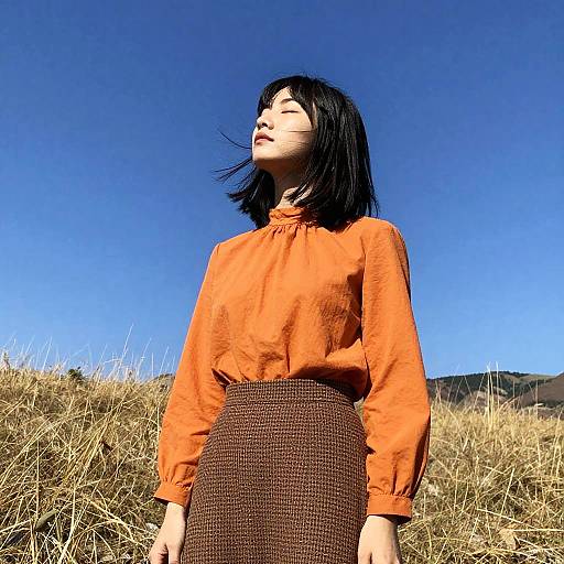 Young Woman Enjoying Sunshine in Field
