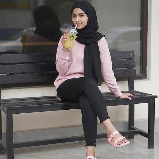 Young Woman in Hijab Holding Drink