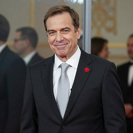 Confident Middle-Aged Man in Dark Suit with Red Lapel Flower