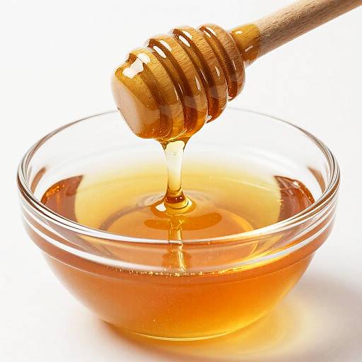 Close-Up Wooden Honey Dipper Drizzling Honey