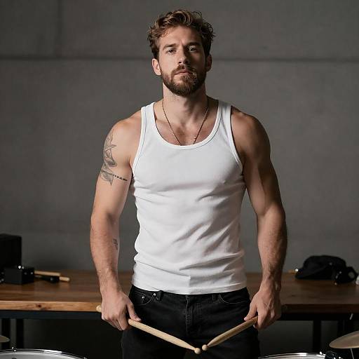 Muscular Drummer in Dimly Lit Studio