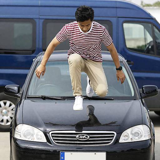 Dynamic Leap onto Black Car Photo