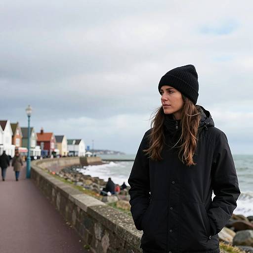 Contemplative Woman on Winter Seaside Promenade