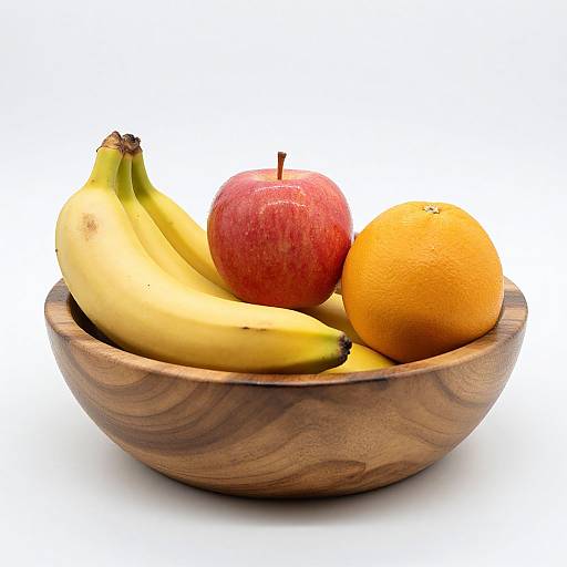 Photograph of a wooden bowl with two yellow bananas, a red apple, and an orange, set against a white background.