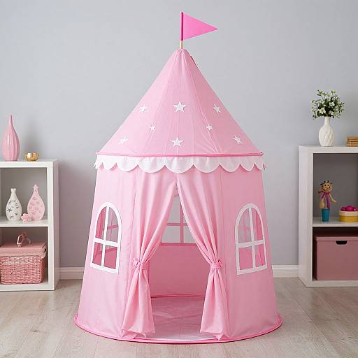 Photograph of a pink, star-decorated children's tent with a flag, white-framed windows, and curtains, flanked by white shel