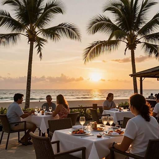 Sunset beach restaurant scene: Silhouetted diners at white-clothed tables, palm trees, ocean view, glassware, candles,