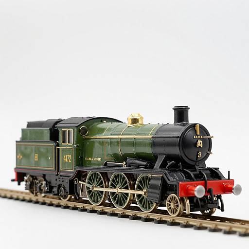 Photograph of a detailed, green and black model steam locomotive with gold accents, numbered 47245, on wooden train tracks.