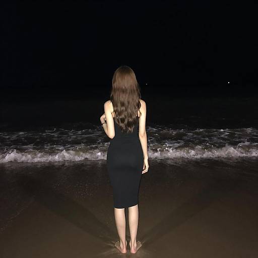 Young Woman on Dark Beach at Night