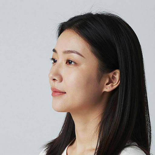 Photograph of an Asian woman with straight black hair, light skin, and red lipstick, looking to the left against a white background.