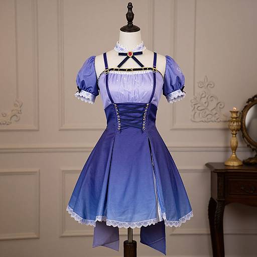 Photograph of a Victorian-style blue dress with white lace trim, black straps, and buttons, displayed on a dress form in an elegant, white-pane