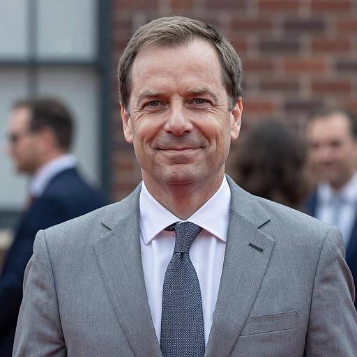 Middle-aged man in gray suit smiling