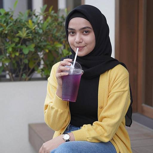 Young Woman in Hijab with Purple Drink