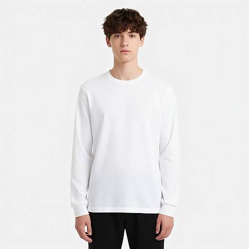 Photograph of a young man with messy brown hair, wearing a plain white long-sleeve shirt and black pants, standing against a white background.