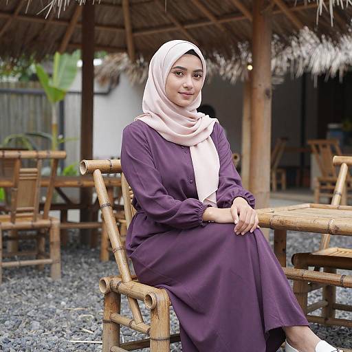 Young Woman in Purple Dress Sitting on Bamboo Chair