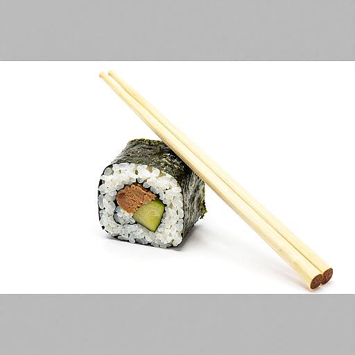 Photograph of a sushi roll with seaweed, white rice, yellow-green filling, and brown topping, paired with wooden chopsticks on a white background