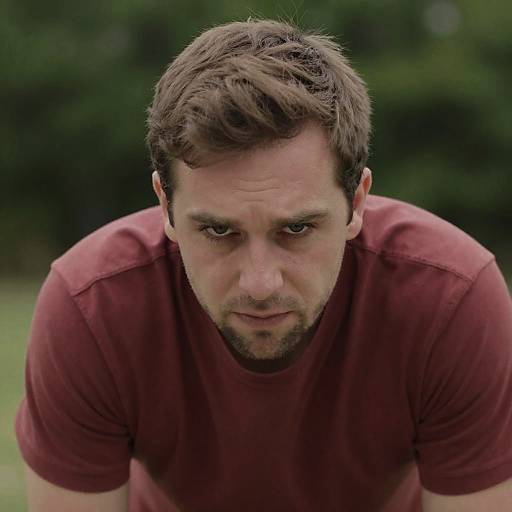 Focused Man in Red Shirt Outdoors