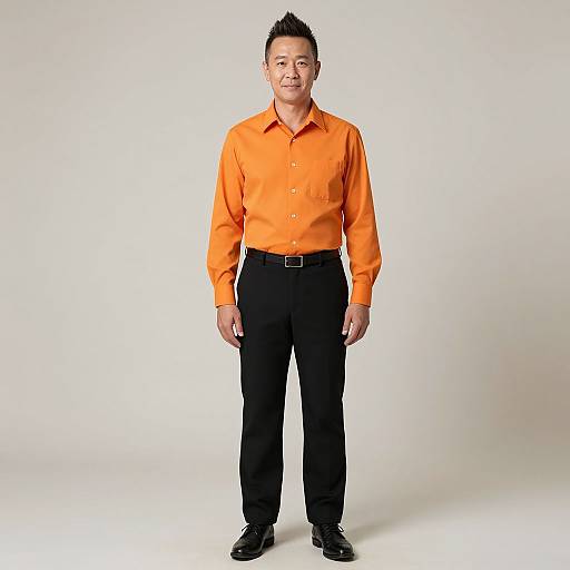 Photograph of a middle-aged Asian man with short black hair, wearing an orange long-sleeve shirt, black pants, and black shoes, standing