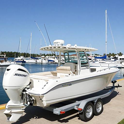 Photograph of a white, motorized fishing boat with an outboard Suzuki engine, docked on a sunny marina, with several other boats and