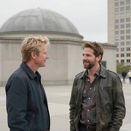 Two Men Talking Outdoors Near Dome Building