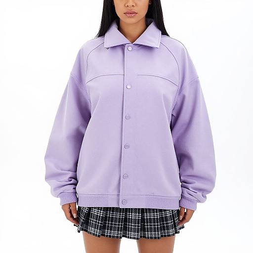 Photograph of an Asian woman with long black hair wearing a light purple button-up shirt and a black plaid skirt against a white background.