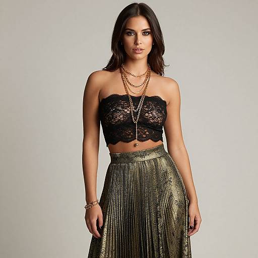 Photograph of a dark-haired woman with medium skin tone, wearing a black lace strapless top and a gold sequined high-waist skirt,
