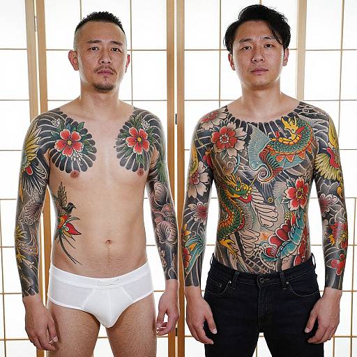 Photograph of two Asian men, one shirtless in white briefs, the other wearing a colorful floral and bird tattoo long-sleeve shirt,