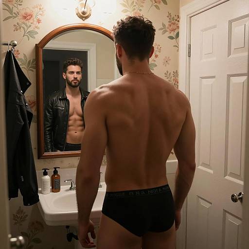Man looking in bathroom mirror with leather jacket reflection