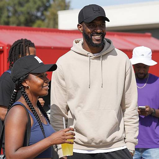 Smiling Black Man and Woman Outdoors with Drink