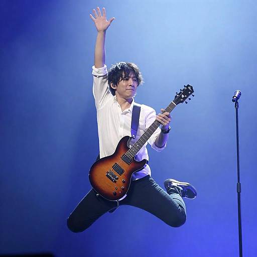 Dynamic Male Guitarist in Mid-Performance