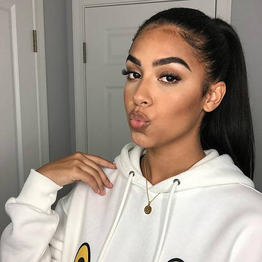 Young Woman Pouting in White Hoodie