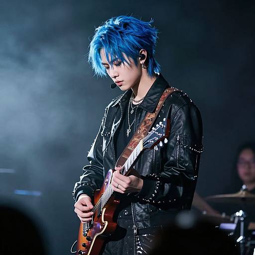 Photograph of a blue-haired rock musician with black leather jacket, playing an electric guitar on stage, surrounded by misty blue light.