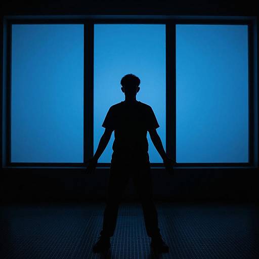 Silhouetted Figure in Dark Industrial Room