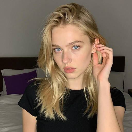 Blonde Woman with Blue Eyes in Black Top