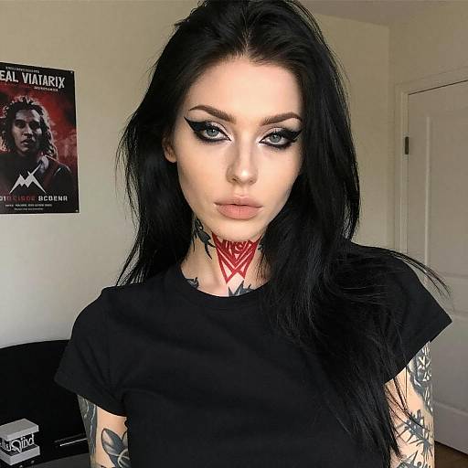 Portrait of Tattooed Woman in Dim Room