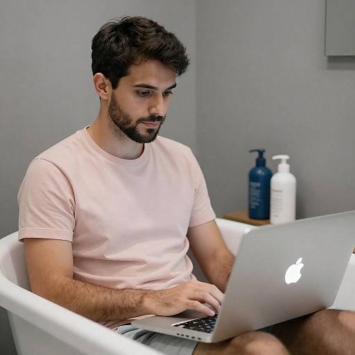 Relaxed Man in Bathtub with Laptop