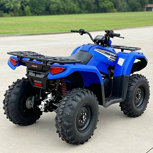 Photograph of a blue, four-wheeled all-terrain vehicle (ATV) with large black tires, red taillights, and black