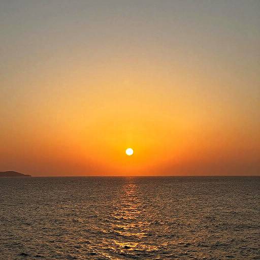 Photograph of a serene sunset over a calm ocean, with the orange sun perfectly centered in the sky, reflecting on the dark, rippling water below