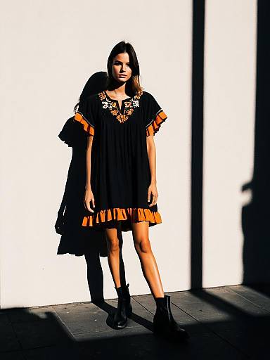 Woman in Boho-Chic Charcoal Dress with Embroidery