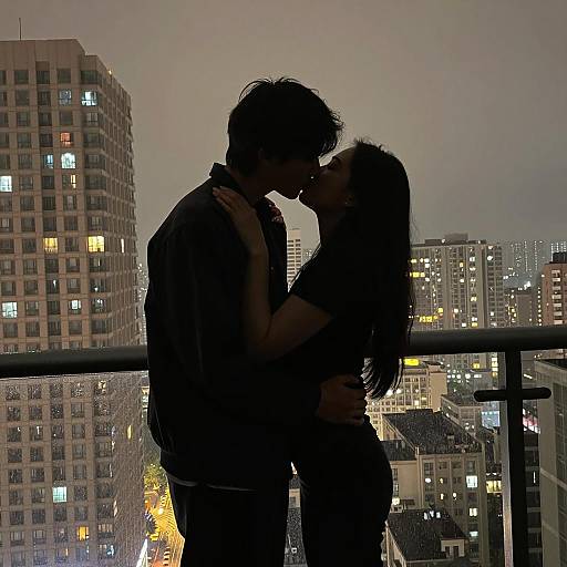 Romantic Night Kiss on a Balcony