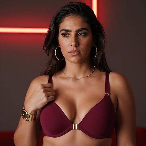 Serious Woman in Maroon Bra with Gold Accessories