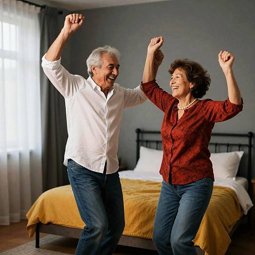 Joyful Dance of Two Seniors in Bedroom
