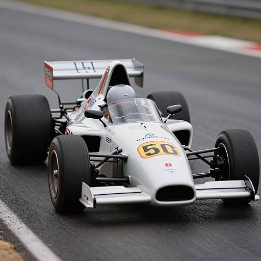 Photograph of two white open-wheel race cars with 