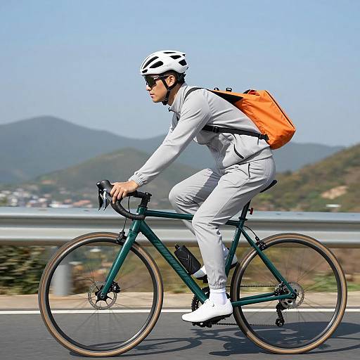 Cyclist in Gray Tracksuit on Scenic Road