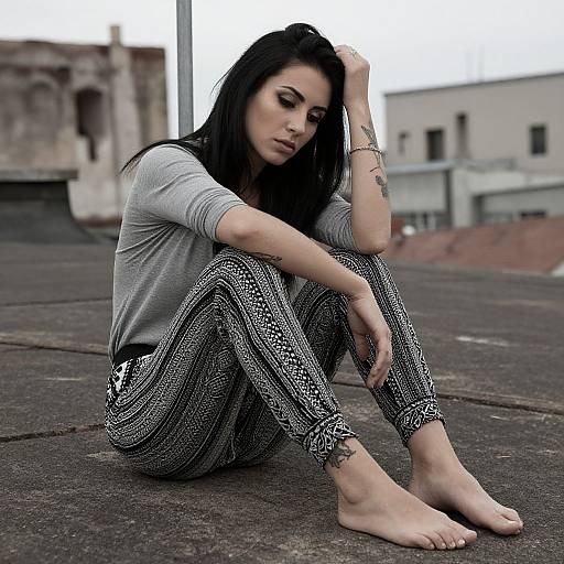 Pensive Tattooed Woman on Rooftop