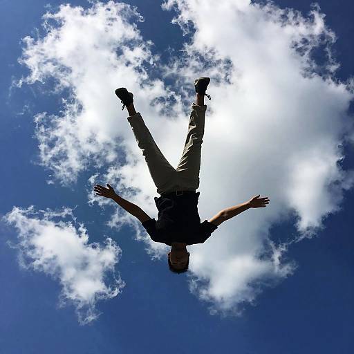 Silhouetted Figure Falling Through Sky