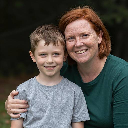 Smiling Woman Embracing Young Boy Outdoors