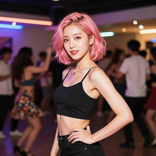 Photograph of a young Asian woman with pink bob haircut, black crop top, and high-waisted black pants, standing confidently in a dimly